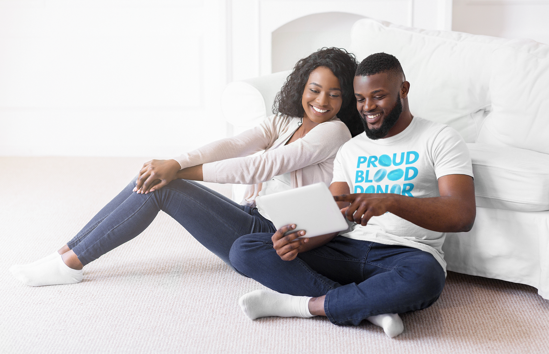 t-shirt-mockup-of-a-couple-checking-a-tablet-in-their-living-room-41054r-el2